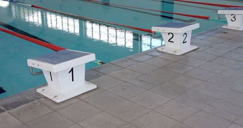 Starting blocks at indoor swimming pool awaiting competitive race