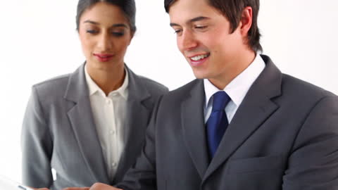 Smiling Business Professionals Collaborating on Tablet