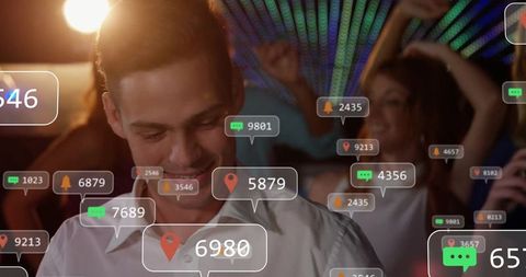 Smiling Man Engaging with Smartphone in Vibrant Nightclub Atmosphere