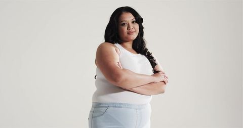 Confident Woman Posing in Casual Wear with Arms Crossed
