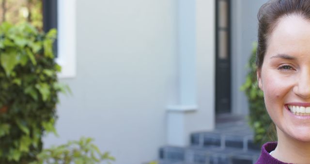 Half face of happy caucasian woman standing and smiling in sunny garden. Lifestyle,relaxation,free time and domestic life,unaltered.