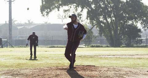Baseball Player Pitching on a Sunny Day at the Park