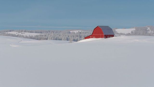 Red Barn Standing on Snowy Ridge, Minimalist Winter Landscape with Treeline and Tracks