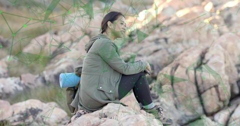 Woman Contemplating Nature on Rocky Terrain