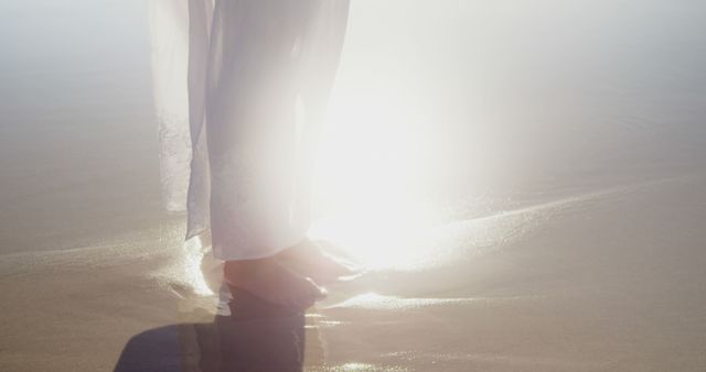 Woman in Flowing White Dress Walking on Shiny Beach at Sunrise - Download Free Stock Images Pikwizard.com