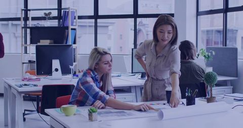 Collaborative Office Meeting with Colleagues Analyzing Data Charts