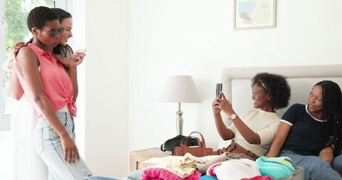 Cheerful Friends Enjoying day and Capturing Memories in Cozy Room