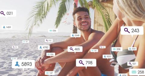 Couple relaxing on beach with floating social media icons