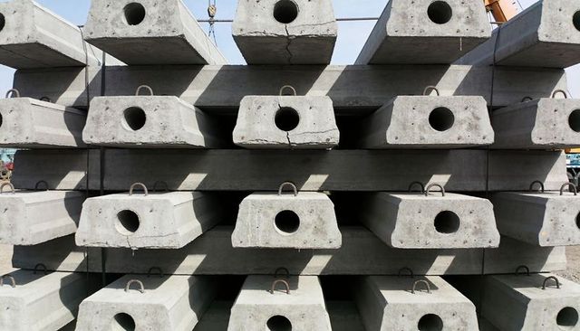 Stacked precast concrete beams with circular ducts and lifting eyes industrial pattern