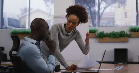 Colleagues Reviewing Documents in Modern Office Environment