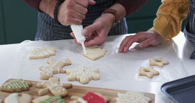 Close-Up of People Decorating Festive Christmas Cookies with Icing - Download Free Stock Images Pikwizard.com