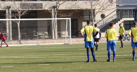 School Team Practicing Soccer on Green Field