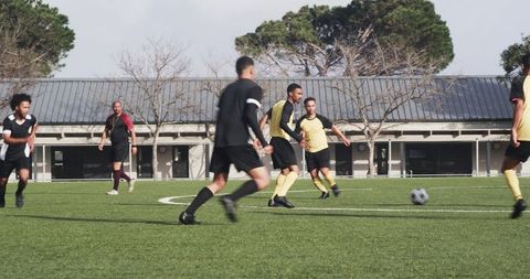Soccer Practice: Coach Observing Players in Action on Sunny Field
