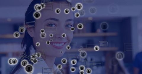 Smiling businesswoman connecting with digital network and chat avatars in coworking workspace