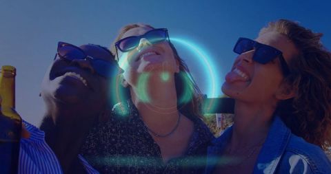 Joyful friends celebrating on rooftop terrace with sunglasses