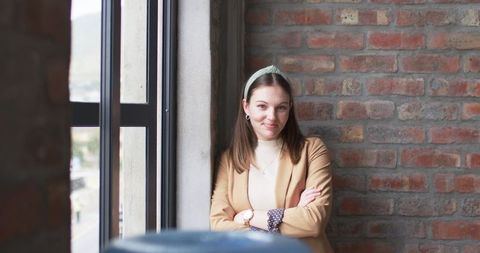 Confident Young Professional Woman in Brick Office Interior - Download Free Stock Images Pikwizard.com