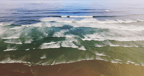 transparent ocean waves rolling onto sandy shore - Download Free Stock Videos Pikwizard.com