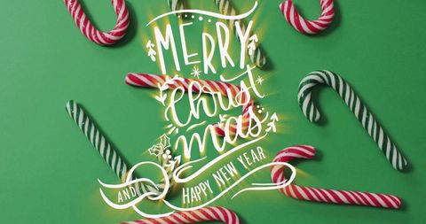 Festive Greeting with Candy Canes on Green Background