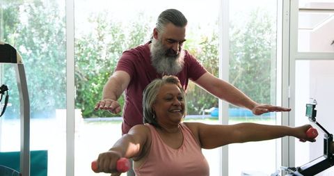 Senior Couple Exercising Together at Home Focusing on Fitness