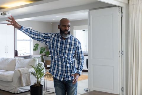 Mature Man Sharing Ideas in Modern Open-Plan Living Room