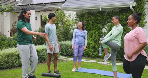 Diverse Group Enjoying Outdoor Fitness Session in Suburban Backyard