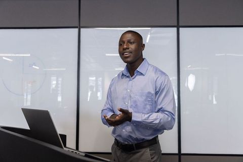 Confident Business Presentation in Modern Meeting Room