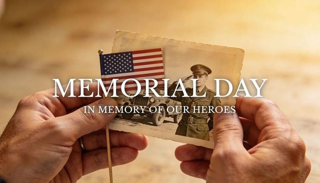 Holding vintage soldier portrait and small us flag while remembering fallen heroes