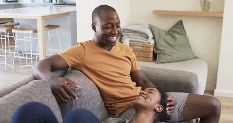 Cozy couple relaxing on sofa in modern home