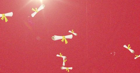 Floating ribboned diploma scrolls on red textured ceiling with bright lens flare and grain