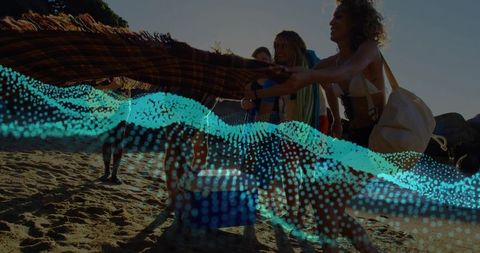 Friends Unfolding Blanket at Beach Sunset with Blue Wave Digital Motion