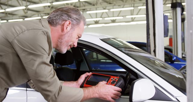 Mechanic Diagnosing Car with Diagnostic Tool in Auto Repair Shop - Download Free Stock Images Pikwizard.com