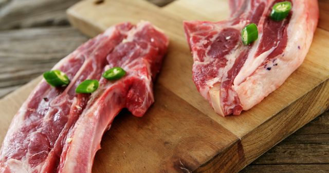 Fresh Raw Lamb Chops with Green Chili Peppers on Wooden Board - Download Free Stock Images Pikwizard.com