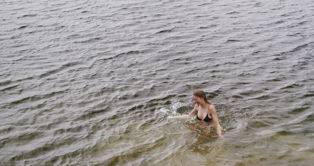 Woman Enjoying Refreshing Swim in Open Water - Download Free Stock Images Pikwizard.com