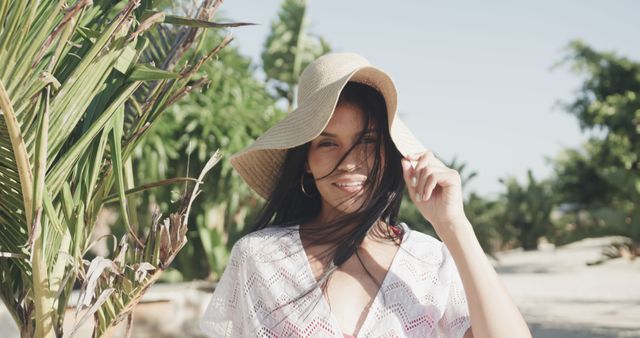 Woman Enjoying Sunny Day on Tropical Beach Wearing Hat and Smiling - Download Free Stock Images Pikwizard.com