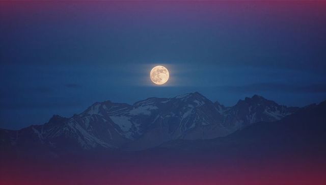 Full Moon Illuminating Mountain Peaks at Night with Alpine Charm