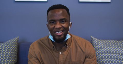 Smiling man social distancing relaxing at home