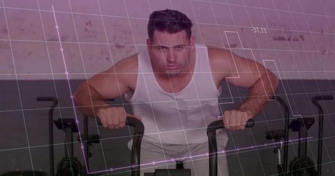 Focused man using air bike with fitness technology data overlay