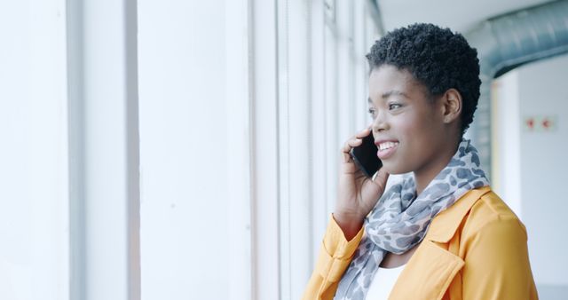 Smiling Woman on Phone Call Looking Out Window in Office - Download Free Stock Images Pikwizard.com