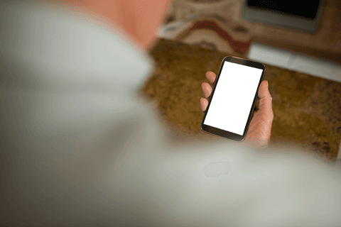 Man Holding Smartphone with Blank Screen in Kitchen Area - Download Free Stock Videos Pikwizard.com