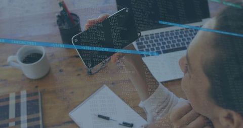 Developer Analyzing Code with Smartphone and Laptop in Home Office