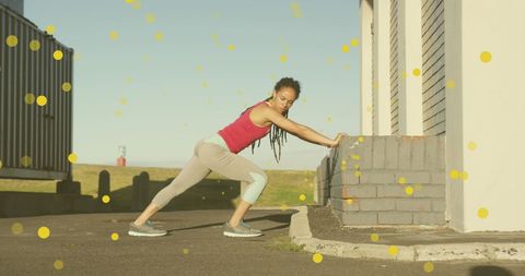 Fit African American Woman Stretching Outdoors with Energetic Overlay