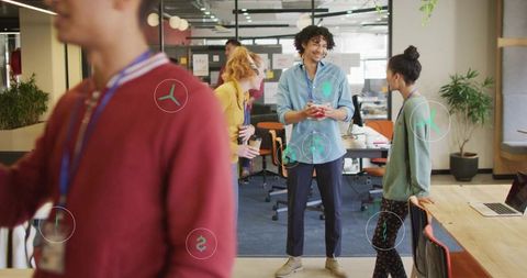 Diverse team having casual discussion in modern open-plan coworking office, teamwork focus