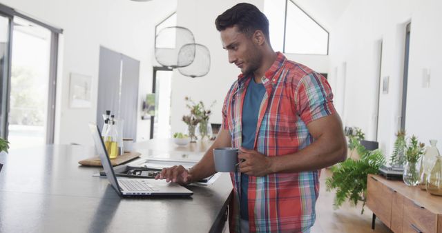 Man Working From Home Using Laptop and Holding Coffee Mug - Download Free Stock Images Pikwizard.com