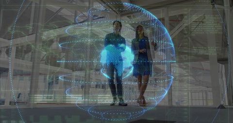 Business professionals interacting with holographic globe in modern office