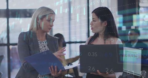 Professional Businesswomen Analyzing Market Data at Modern Trading Desk