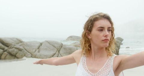 Calm Woman Practicing Yoga Stretch by Misty Beachfront - Download Free Stock Images Pikwizard.com