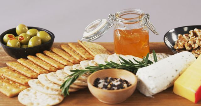 Cheese and Crackers with Olives, Nuts and Honey Jar on Wood - Download Free Stock Images Pikwizard.com