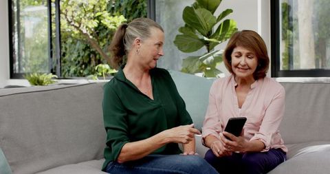 Mature Women Bonding and Chatting with Smartphone at Home