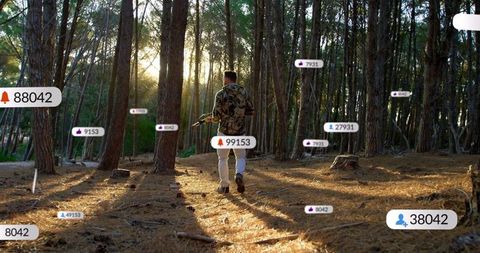 Man Walking with Camera in Forest Under Sun during Golden Hour