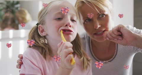 Mother and Daughter Brushing Teeth with Heart Decorations